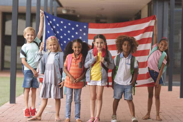 kids in front of American Flag