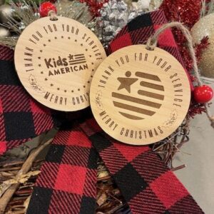 up close picture of both sides of a double sided wooden christmas ornament thanking veterans